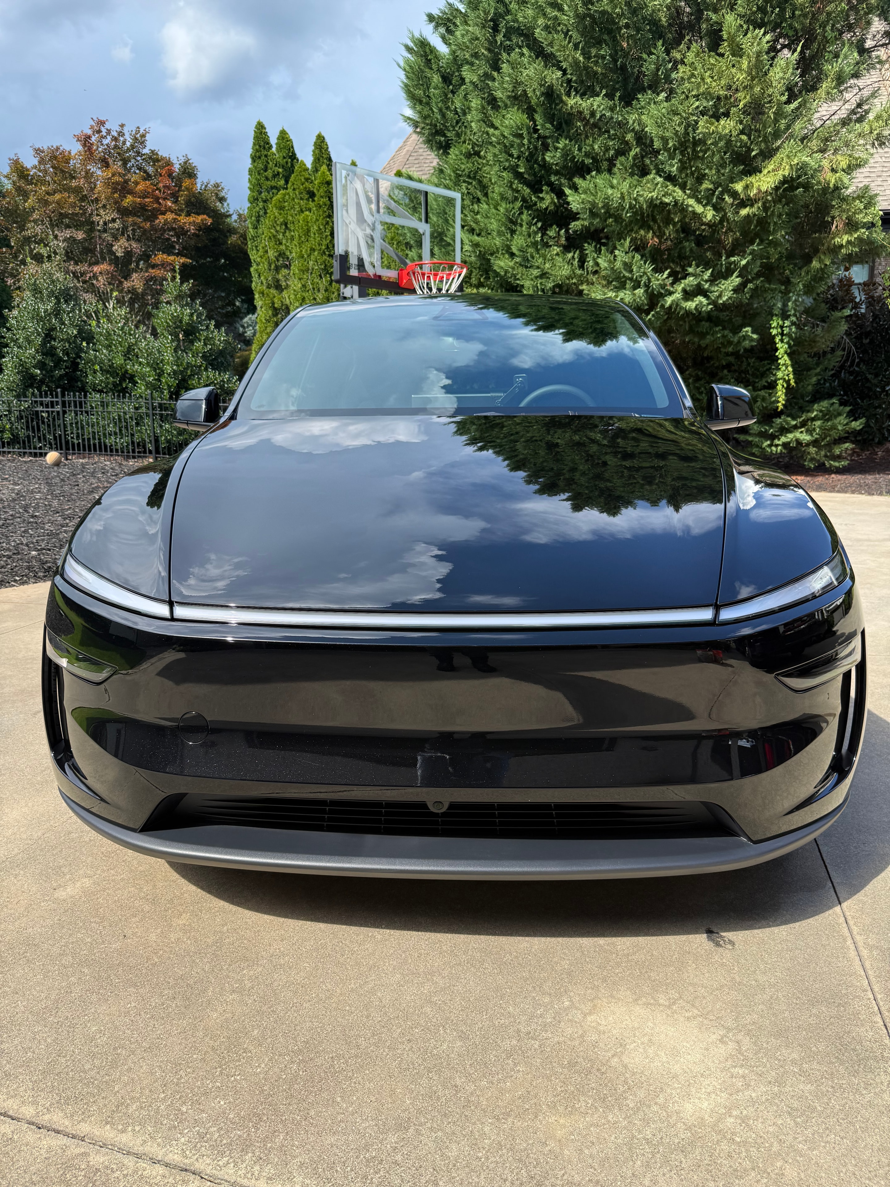 Blue sedan with glossy paint after mobile detailing service